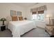 Bright bedroom with a comfortable queen-sized bed, decorative pillows, and an inviting window view at 3119 Knowlton Ln, Charlotte, NC 28205