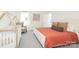 Well-lit bedroom includes a modern crib, hardwood floors, and a comfy chair at 3119 Knowlton Ln, Charlotte, NC 28205