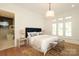 Comfortable bedroom features natural light and a decorative area rug on hardwood flooring at 3119 Knowlton Ln, Charlotte, NC 28205