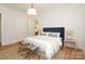 Light-filled bedroom with hardwood floors, large bed, and accent tables offers a calming retreat at 3119 Knowlton Ln, Charlotte, NC 28205