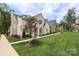 Elegant brick home featuring a well-manicured lawn, a large front yard and mature trees at 3119 Knowlton Ln, Charlotte, NC 28205
