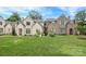 Beautiful brick homes with green lawns and manicured landscaping under a bright blue sky at 3119 Knowlton Ln, Charlotte, NC 28205