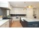 Spacious kitchen with hardwood floors, an island with sink, stainless steel appliances, and white cabinetry at 3119 Knowlton Ln, Charlotte, NC 28205