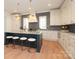 Bright kitchen features a center island, wooden floor, modern appliances and countertops at 3119 Knowlton Ln, Charlotte, NC 28205