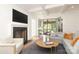 Cozy living room with fireplace, coffered ceiling, and French doors to the screened porch at 3119 Knowlton Ln, Charlotte, NC 28205
