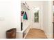 Mudroom featuring built-in storage, coat hooks, bench and white paneled walls at 3119 Knowlton Ln, Charlotte, NC 28205