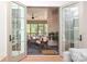 View from indoors through open French doors to a comfortable screened-in porch at 3119 Knowlton Ln, Charlotte, NC 28205