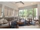 Relaxing screened porch with comfortable seating, decorative rug and lots of natural light at 3119 Knowlton Ln, Charlotte, NC 28205