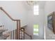 Bright staircase features natural light, hardwood railing, and a decorative painting at 3119 Knowlton Ln, Charlotte, NC 28205