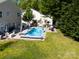 An aerial view shows a sparkling pool, spacious backyard, and a glimpse of the neighborhood's lush greenery at 320 Allspice Rd, Fort Mill, SC 29708