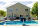 The backyard features a sparkling inground pool, ample seating, and lush greenery creating a relaxing outdoor oasis at 320 Allspice Rd, Fort Mill, SC 29708
