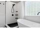 Modern bathroom featuring a standalone tub, sleek black fixtures, and tiled walk-in shower at 320 Allspice Rd, Fort Mill, SC 29708
