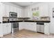 Bright kitchen with white cabinets, stainless steel appliances, granite countertops, and stylish backsplash at 320 Allspice Rd, Fort Mill, SC 29708