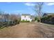 Expansive backyard featuring a large lawn and mature trees providing shade and privacy at 3217 Deep Meadow Ln, Charlotte, NC 28210