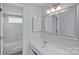 Well-lit bathroom with a tub, shower, and stylish vanity, offering a clean and refreshing space at 3217 Deep Meadow Ln, Charlotte, NC 28210
