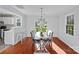 Bright dining area with hardwood floors, modern chandelier, and sliding doors leading to the backyard at 3217 Deep Meadow Ln, Charlotte, NC 28210