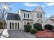 Beautiful two-story home with a well-manicured lawn, a paved driveway, and mature landscaping at 3217 Deep Meadow Ln, Charlotte, NC 28210