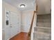Welcoming foyer featuring hardwood floors, staircase, and a conveniently located coat closet at 3217 Deep Meadow Ln, Charlotte, NC 28210