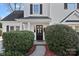 Inviting home entrance with a dark front door framed by manicured bushes and a charming walkway at 3217 Deep Meadow Ln, Charlotte, NC 28210