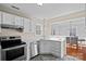 Bright kitchen featuring white cabinets, stainless steel appliances, and plenty of counter space at 3217 Deep Meadow Ln, Charlotte, NC 28210