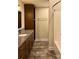 Bathroom with granite countertops, wood cabinets, and shower at 341 Canvasback Rd, Mooresville, NC 28117