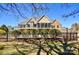 A charming home has a black metal fence surrounding a backyard pool and green shrubs at 341 Canvasback Rd, Mooresville, NC 28117