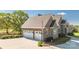 Spacious three-car garage with ample parking and a brick exterior at 341 Canvasback Rd, Mooresville, NC 28117