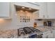 Modern kitchen featuring a stainless steel gas range, backsplash, and custom cabinetry at 341 Canvasback Rd, Mooresville, NC 28117