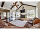 Open living room featuring a stone fireplace, hardwood floors, and access to an outdoor deck at 341 Canvasback Rd, Mooresville, NC 28117