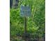 A sign showing lake access for the Woodland Hills community and gate closing hours at 341 Canvasback Rd, Mooresville, NC 28117