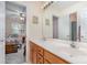 Bathroom featuring double sinks, wood cabinets and mirror over vanity at 3905 Farlow Rd, Charlotte, NC 28269