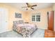 Quaint bedroom with patterned bedding and a ceiling fan, creating a peaceful and comfortable atmosphere at 3905 Farlow Rd, Charlotte, NC 28269