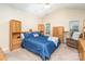 Traditional bedroom with blue bedding and wooden furniture, providing a functional and comfortable space at 3905 Farlow Rd, Charlotte, NC 28269