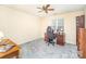 Bright bedroom with a ceiling fan, carpeted floors, and a dark wood desk and bookcase at 3905 Farlow Rd, Charlotte, NC 28269