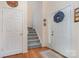 Welcoming foyer with hardwood floors, leading to a staircase at 3905 Farlow Rd, Charlotte, NC 28269