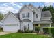 Charming two-story home featuring gray siding, well-manicured lawn, and attached two-car garage at 3905 Farlow Rd, Charlotte, NC 28269