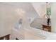 Hallway with wooden railings, light beige walls and decorative niche with an arched window at 3905 Farlow Rd, Charlotte, NC 28269