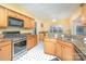 Well-lit kitchen features stainless steel appliances, granite counters, and ample cabinet space at 3905 Farlow Rd, Charlotte, NC 28269