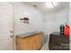 Functional laundry room with modern appliances, storage cabinets, and tiled flooring at 3905 Farlow Rd, Charlotte, NC 28269