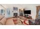 Bright living room featuring a fireplace, modern TV, and an eye-catching area rug on hardwood floors at 3905 Farlow Rd, Charlotte, NC 28269