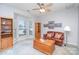 Cozy living room with natural light, carpeted floors, a leather sofa, and wooden accents at 3905 Farlow Rd, Charlotte, NC 28269