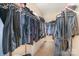 Spacious walk-in closet with hanging racks, shelving, storage and carpeted floor at 3905 Farlow Rd, Charlotte, NC 28269