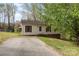 Ranch home featuring light siding, dark shutters and trim, with a driveway leading up to the front entrance at 410 E Lee Ave, Bessemer City, NC 28016