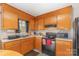 Bright kitchen featuring wooden cabinets and black appliances at 410 E Lee Ave, Bessemer City, NC 28016