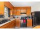 Cozy kitchen featuring wooden cabinets and black appliances at 410 E Lee Ave, Bessemer City, NC 28016