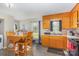 Cozy kitchen and dining room with matching wooden cabinets and chairs, lots of natural light at 410 E Lee Ave, Bessemer City, NC 28016