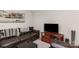 Comfortable living room featuring an oversized couch, laminate floors, and a large screen tv at 410 E Lee Ave, Bessemer City, NC 28016