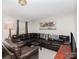 Comfortable living room featuring an oversized couch, laminate floors, and natural light from the window at 410 E Lee Ave, Bessemer City, NC 28016