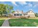 Expansive backyard featuring a spacious deck, lush lawn, mature trees, and a charming gazebo, perfect for outdoor entertaining at 421 Tranquil Bay Cir, Norwood, NC 28128