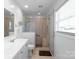 Bright bathroom with walk-in shower, neutral tile, white vanity, and modern fixtures at 421 Tranquil Bay Cir, Norwood, NC 28128